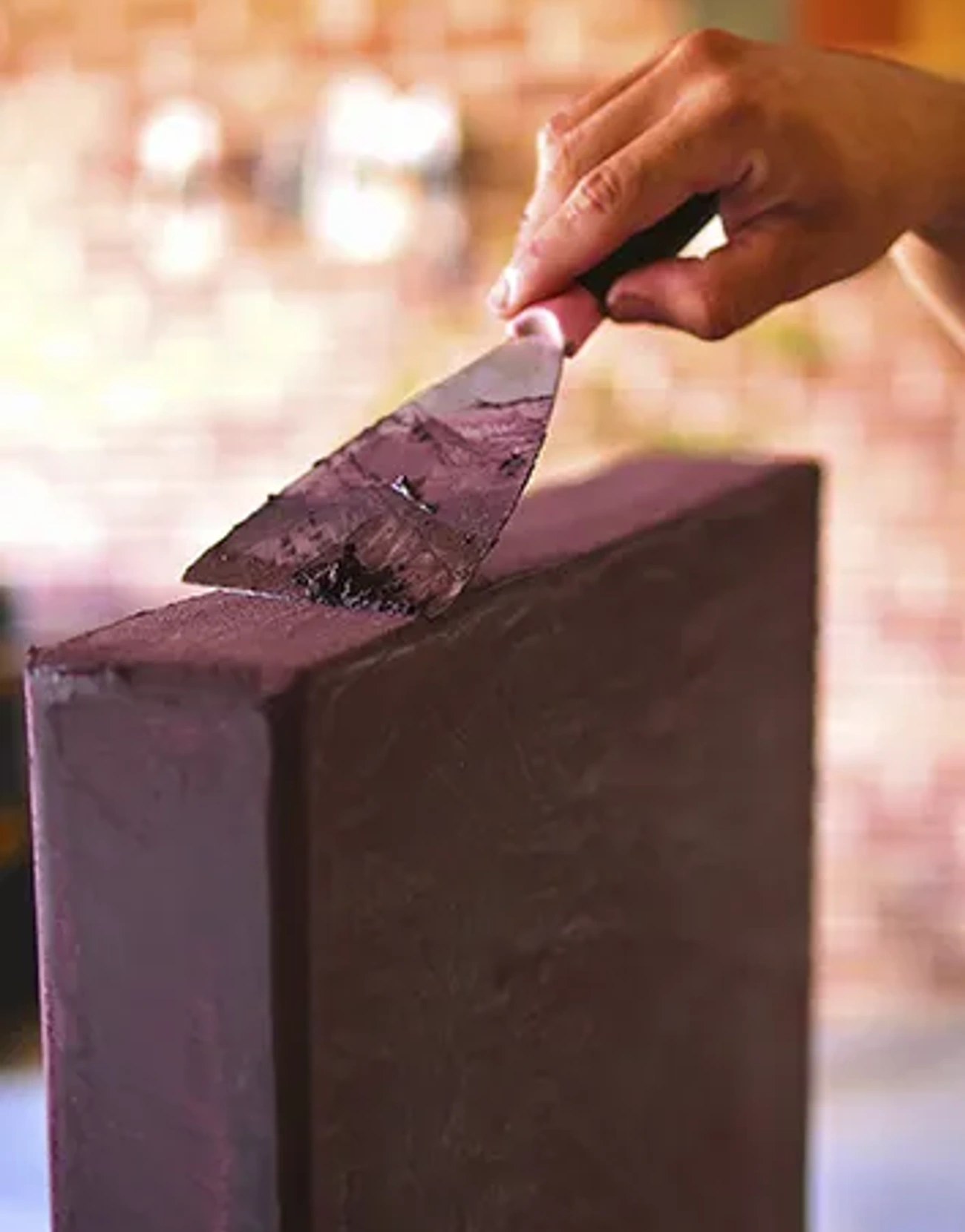 Close view of microcement being applied by hand