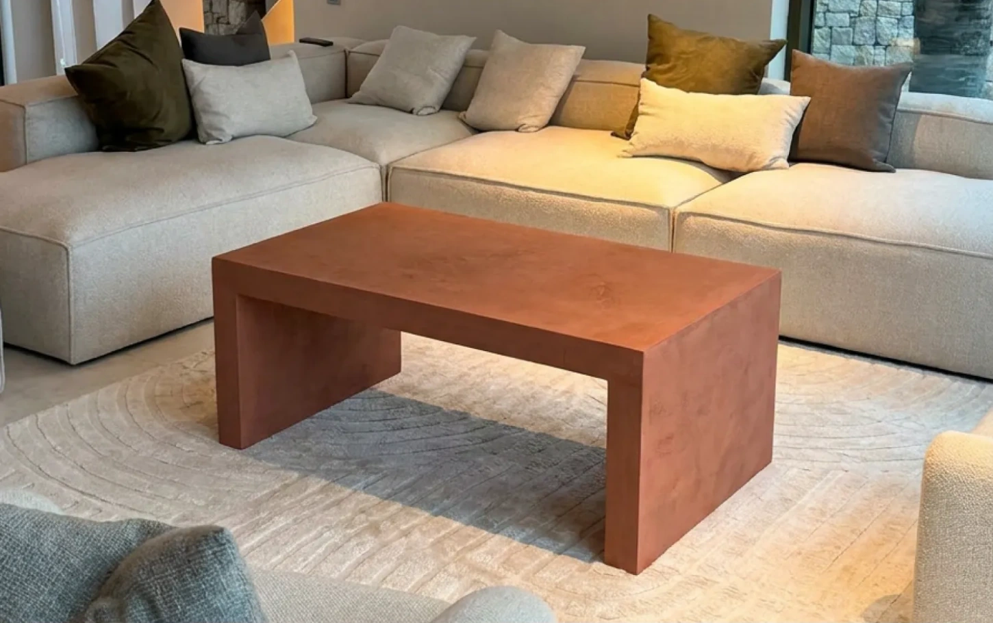 Finished terracotta-toned microcement table in its new home