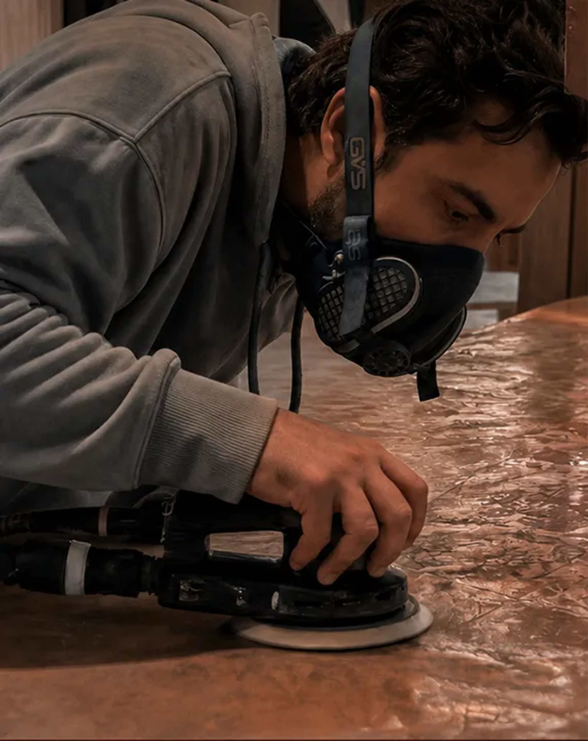 Artisan carefully finishing a textured surface by hand