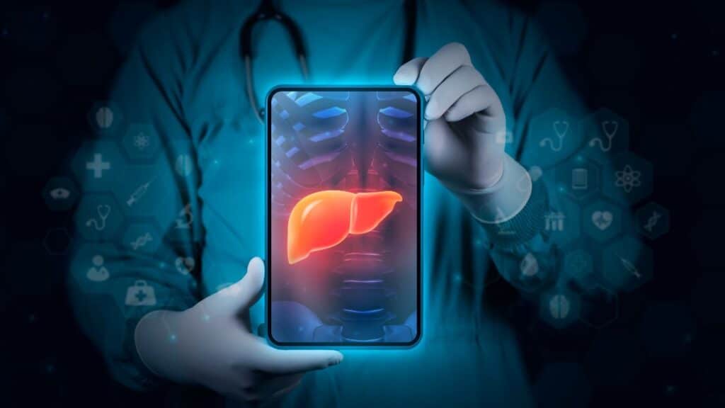 imagem-com-fundo-azul-tecnologico-e-a-tela-de-um-tablet-com-imagem-de-um-raio-x-de-um-figado-shutterstock